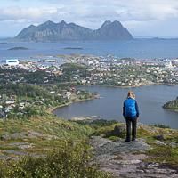 Hiker looking at the town of Svolvær in the Lofoten Hiker looking at the town of Svolvær in the Lofoten